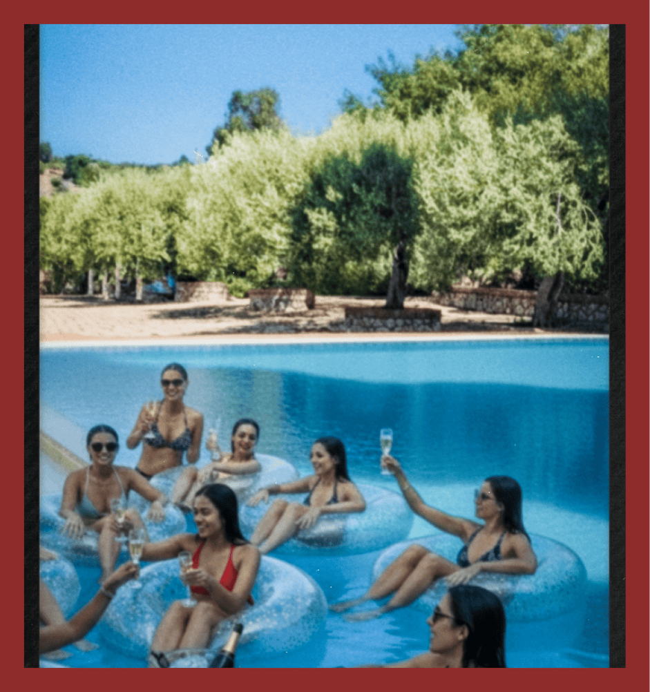 Women enjoying drinks on pool floats at a luxury villa in Los Angeles, California, perfect for summer leisure and outdoor relaxation.