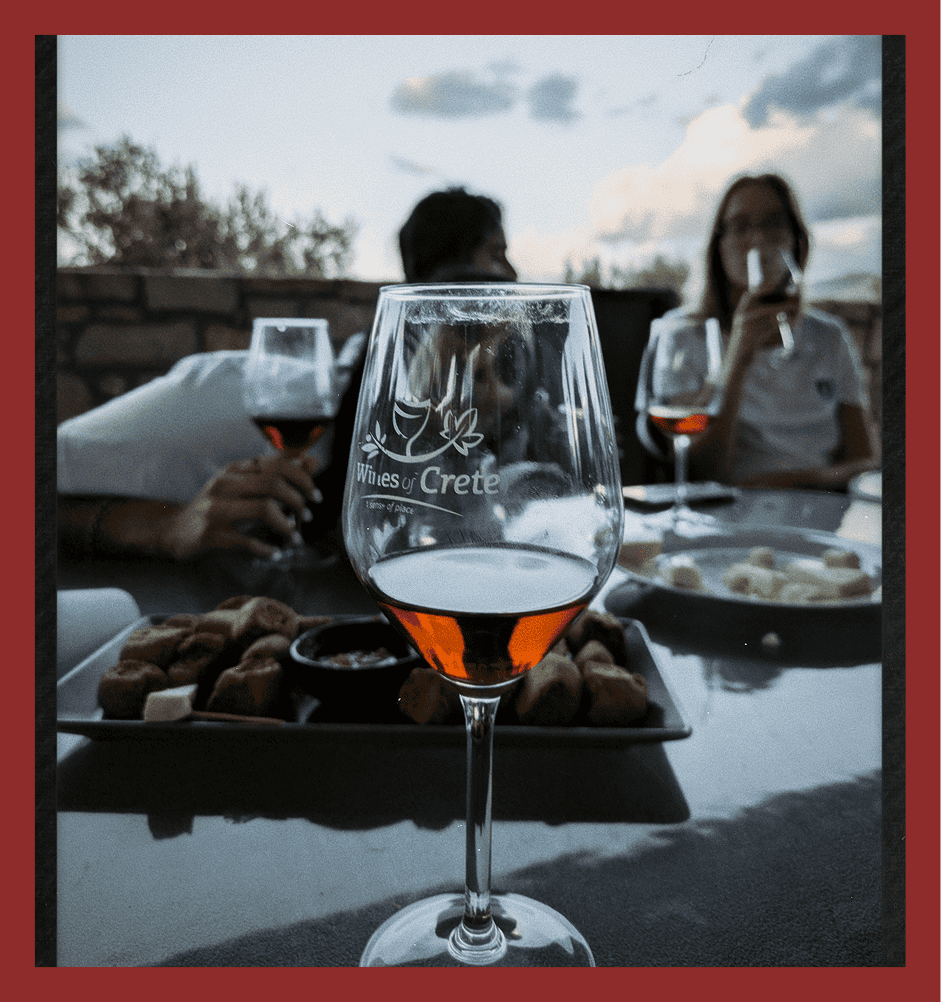 Elegant glass of rosé wine at outdoor dining in Crete.