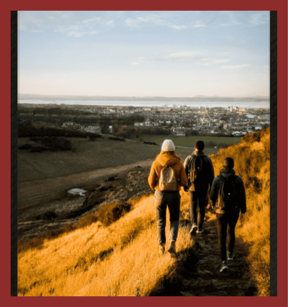 Beautiful scenic hike overlooking a town with four people enjoying outdoor adventure.