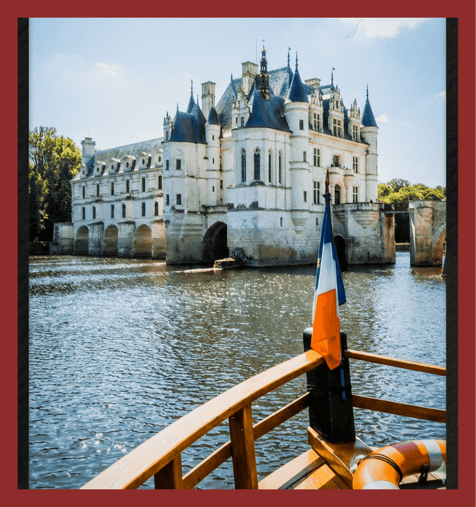 Picturesque medieval castle surrounded by river in France, ideal for travel and photography.
