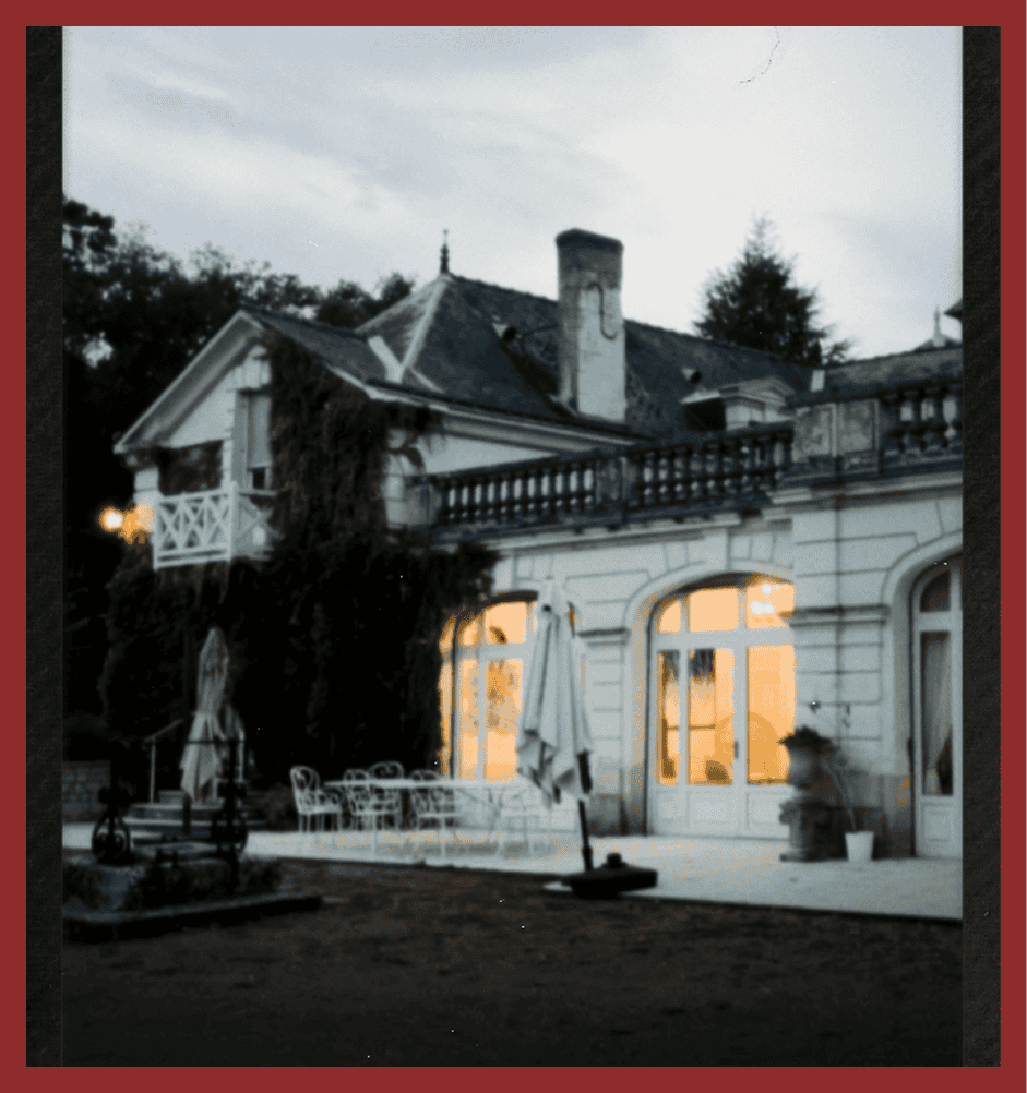 London townhouse with warm-lit windows and outdoor patio in the evening.